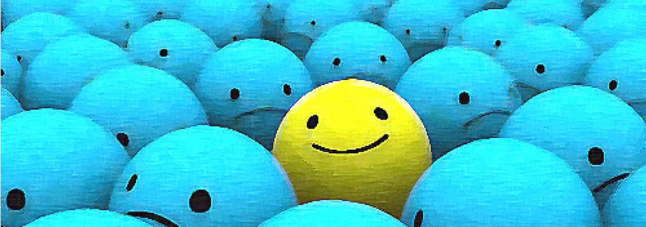 illustration of one yellow round ball with a smiley face surrounded by blue round balls with frown faces.